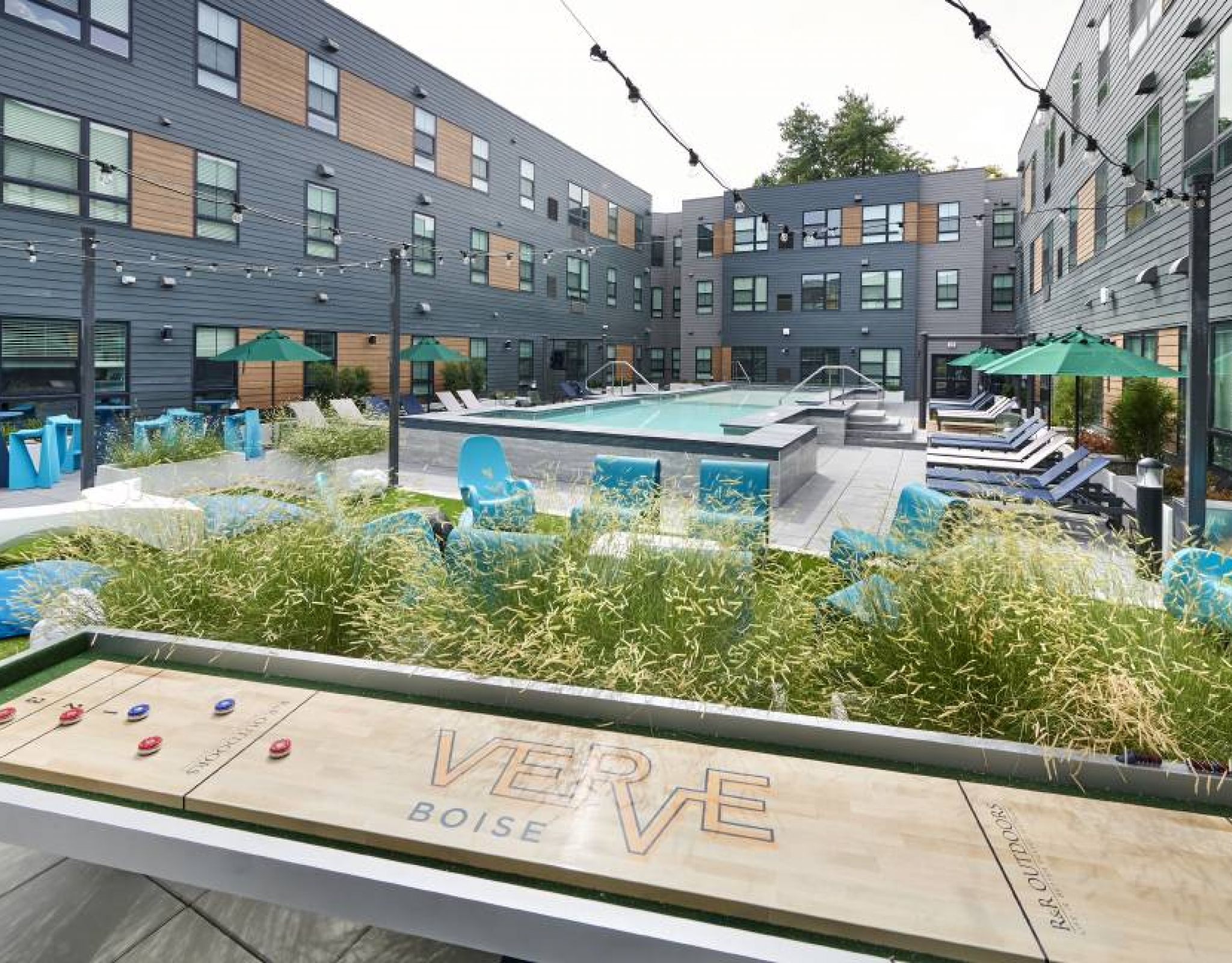 A stylish pool deck at VERVE Boise with contemporary lounge seating and a refreshing swimming pool.
