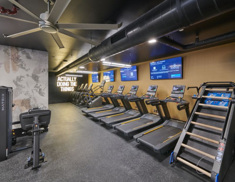 VERVE Boise fitness center with modern exercise equipment and TVS.