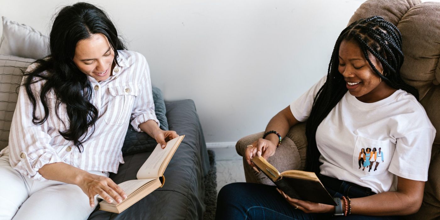 two people sitting and reading books