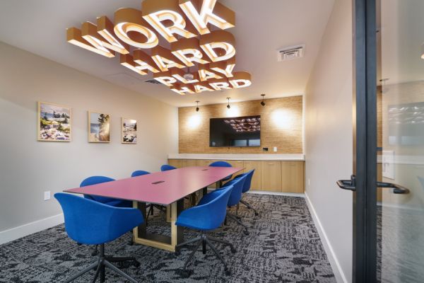 VERVE Boise private conference room with large table and TV.