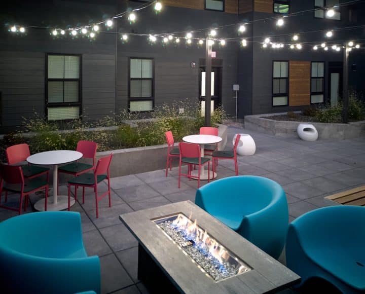 VERVE Boise outdoor lounge area with fire lit at night